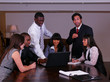 Six young multicultural executives discuss business.