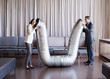 Business people holding metal tubing in hotel lobby
