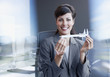Businesswoman holding calipers in office