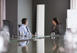 Business people looking at large ruler in conference room