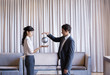 Business people high-fiving in hotel lobby