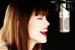 young artist woman recording in a studio