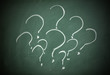 Question marks on a blackboard