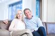 Photo: Smiling couple sitting on couch Smiling couple sitting on couch