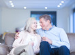 Happy couple drinking champagne on couch