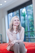 Smiling mature woman sitting on futon