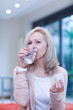 Mature woman taking medicine