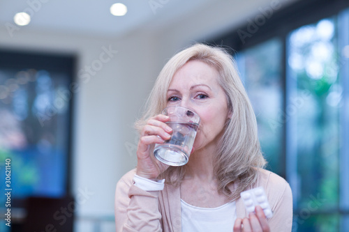 Photo: Mature woman taking medicine Mature woman taking medicine