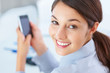 Attractive businesswoman using mobile phone