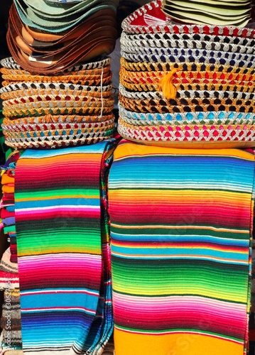 Photo: Mexican serape colorful stacked and charro hats Mexican serape colorful stacked and charro hats