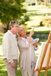 Senior couple painting in the park Senior couple painting in the park