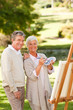 Senior couple painting in the park Senior couple painting in the park