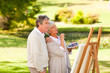 Senior couple painting in the park Senior couple painting in the park