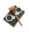 Judge's gavel and handcuffs on black legal book isolated