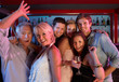 Group Of People Having Fun In Busy Bar