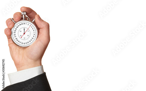 Photo: Man's hand holding stopwatch. Man's hand holding stopwatch.