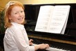 Nettes rothaariges Mädchen spielt Klavier