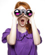 Teen red-haired girl with binoculars isolated on white backgroun