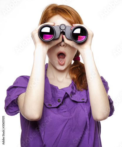 Photo: Teen red-haired girl with binoculars isolated on white backgroun Teen red-haired girl with binoculars isolated on white backgroun