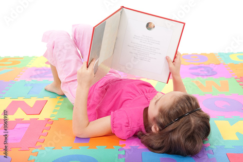 Photo: Girl child reading book Girl child reading book