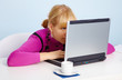 Young girl - is looking closely at laptop monitor Young girl - is looking closely at laptop monitor