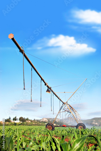 Photo: Modern irrigation system watering a farm field Modern irrigation system watering a farm field
