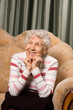 Portrait of the old woman on a sofa