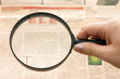 Magnifying glass in hand and text - business background Magnifying glass in hand and text - business background