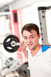 Man lifting weights in fitness club - barbell Man lifting weights in fitness club - barbell
