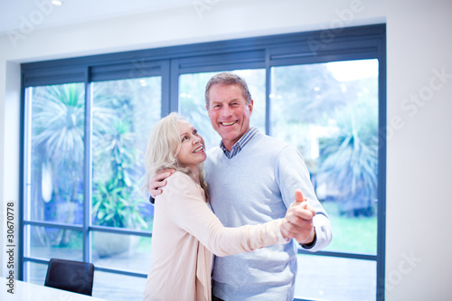 Photo: Happy couple dancing at home Happy couple dancing at home