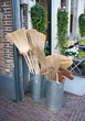 wooden brooms for sale in iron buckets in a garden center wooden brooms for sale in iron buckets in a garden center