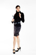 Young beautiful woman with magazine and pen standing tall