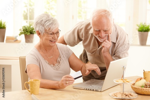 Photo: Happy older couple doing online shopping Happy older couple doing online shopping