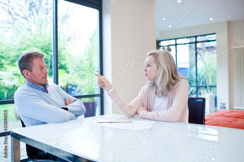 Photo: Couple at table arguing Couple at table arguing
