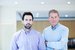 Confident man standing with adult son
