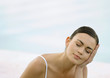 Young woman resting head on hand