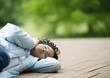 Young woman lying down outdoors