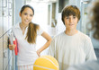 Young teens standing near school lockers