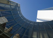 Skyscraper with reflection of buildings on facade, low angle, abstract view
