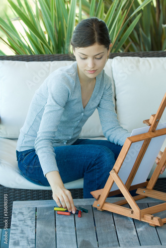 Photo: Young woman drawing with easel Young woman drawing with easel
