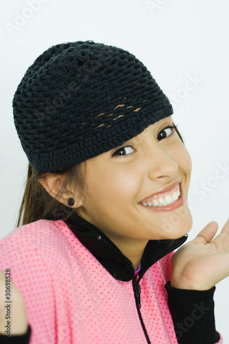 Photo: Teen girl, holding up hands, smiling at camera, portrait Teen girl, holding up hands, smiling at camera, portrait