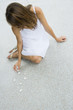 Woman sitting on the ground arranging pebbles