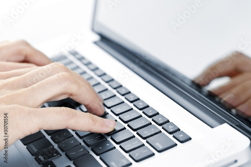 Photo: Hands typing on laptop keyboard Hands typing on laptop keyboard