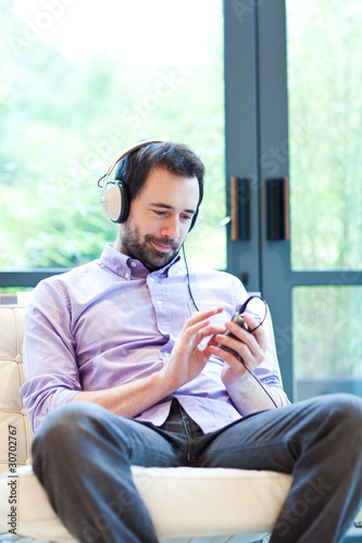 Photo: Man listening to music with MP3 player Man listening to music with MP3 player