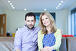 Smiling couple sitting on couch
