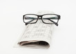 Reading glasses sitting on a newspaper