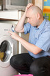 man doing laundry at his home