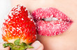 woman's mouth with red strawberry covered with sugar woman's mouth with red strawberry covered with sugar