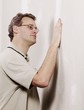 Man Checking The Smoothness Of A Wall