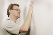 Man Checking The Smoothness Of A Wall